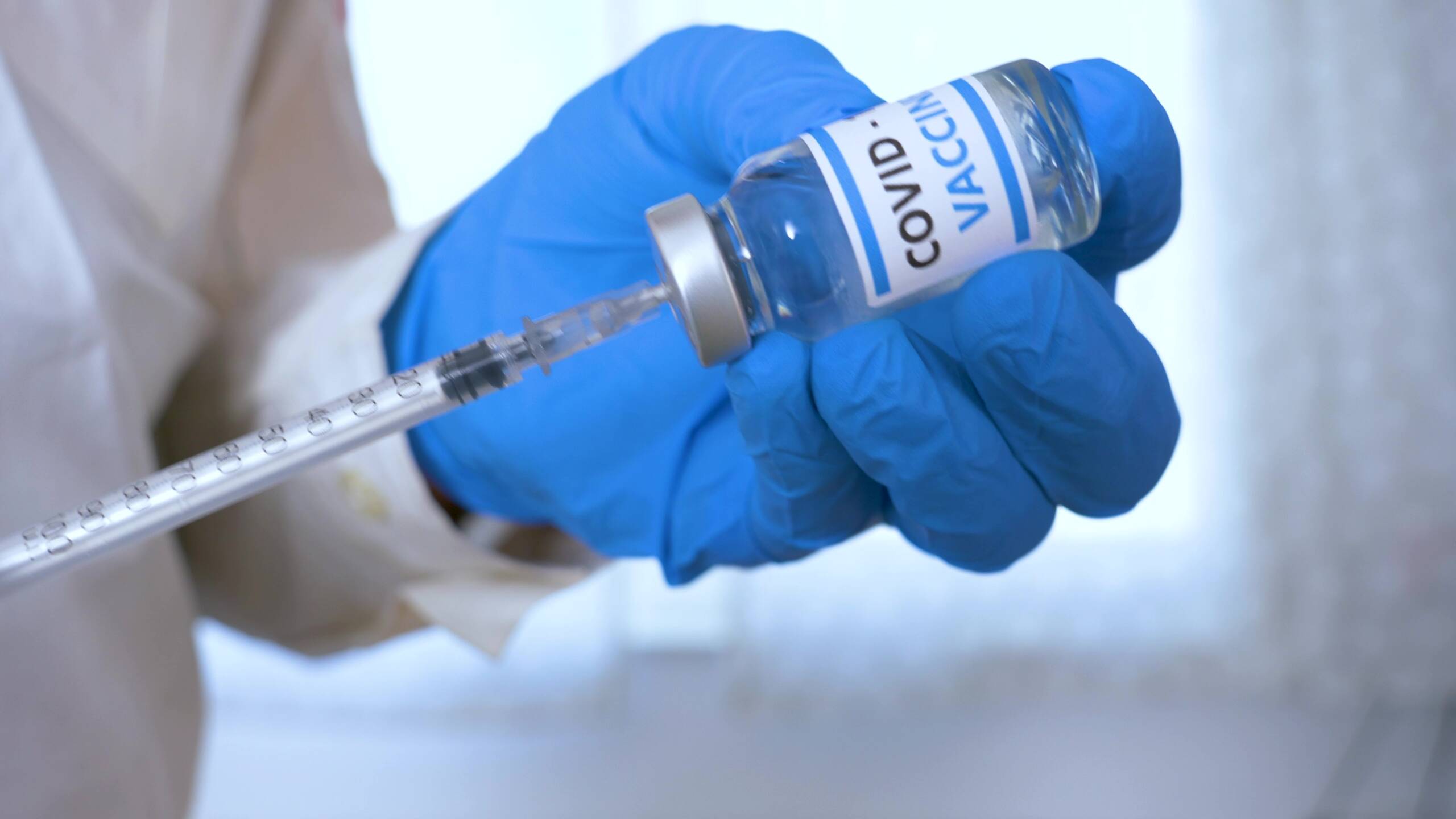 doctor-hands-with-blue-surgical-gloves-holding-syr-UU399W3_Moment Moderna COVID-19 Vaccine Available